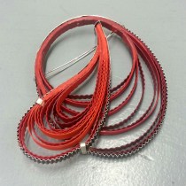 Red paper and silver brooch by Clara Breen